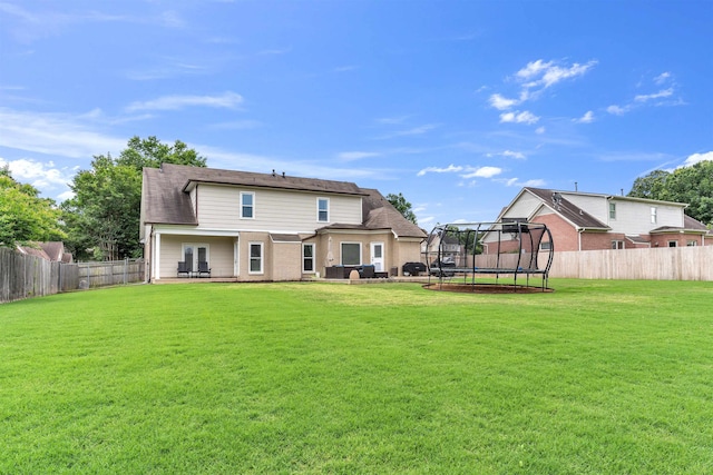 12262 Kathleen Cv, Arlington, TN 38002 - back of house featuring a trampoline and a patio