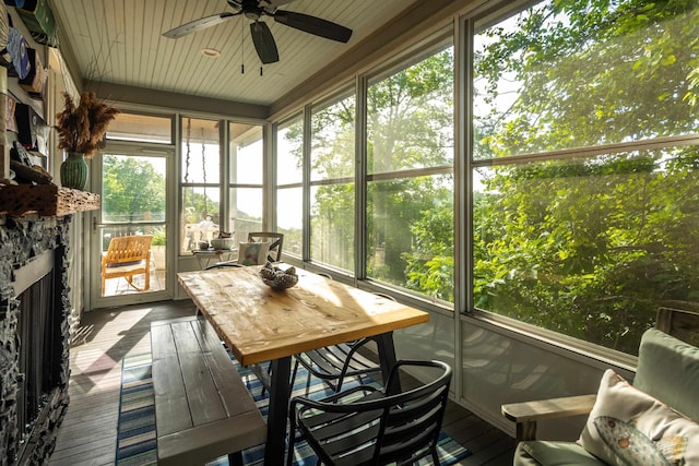 8 Shady Oak Cv, Iuka, MS 38852 - sunroom with ceiling fan, outdoor dining space, and a stone fireplace