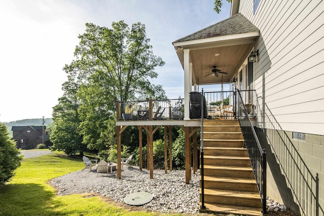 8 Shady Oak Cv, Iuka, MS 38852 - wooden deck featuring ceiling fan, a fire pit, a lawn, and stairs