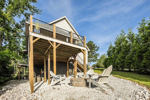 8 Shady Oak Cv, Iuka, MS 38852 - back of house with a fire pit, a wooden deck, and stairway