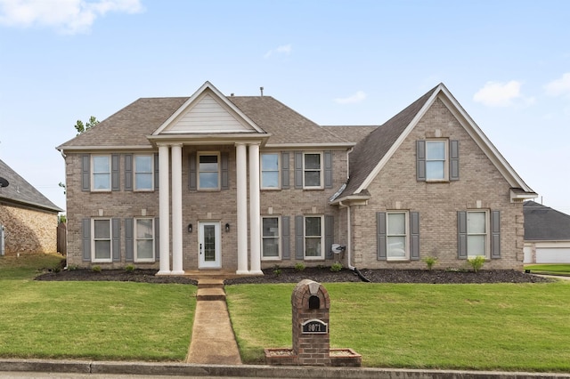 9071 E Tefall Cv, Cordova, TN 38016 - greek revival house with a front yard, brick siding, and roof with shingles