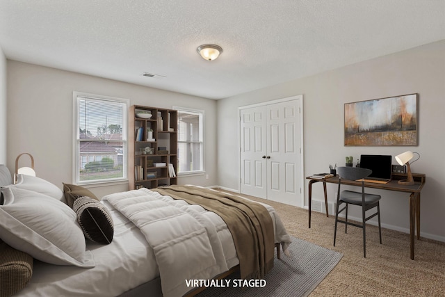 9071 E Tefall Cv, Cordova, TN 38016 - carpeted bedroom featuring a closet, baseboards, and a textured ceiling