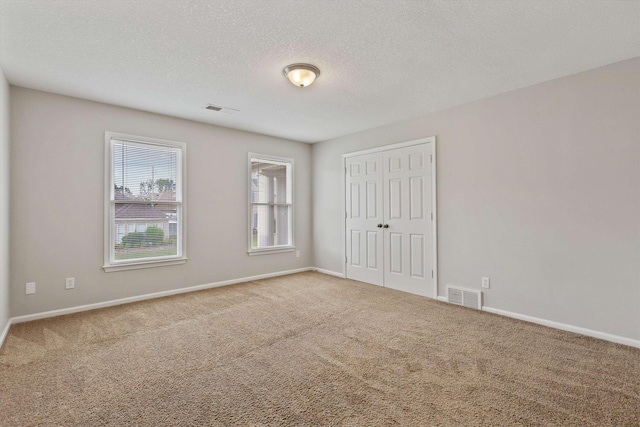 9071 E Tefall Cv, Cordova, TN 38016 - unfurnished bedroom with carpet floors, a closet, baseboards, and a textured ceiling
