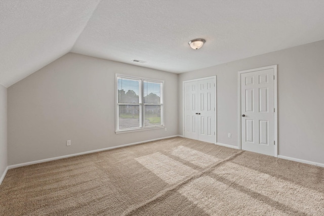 9071 E Tefall Cv, Cordova, TN 38016 - unfurnished bedroom with carpet, vaulted ceiling, baseboards, and a textured ceiling