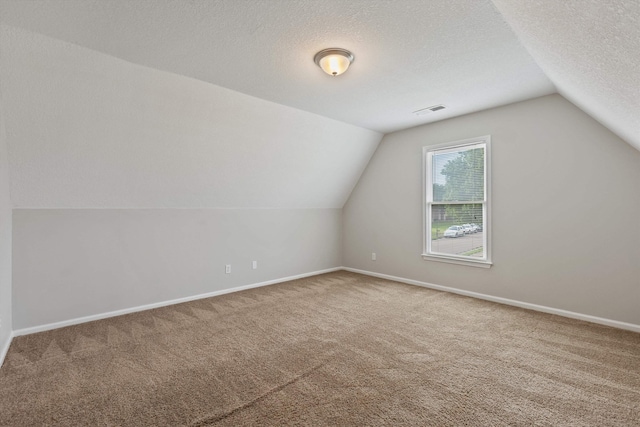 9071 E Tefall Cv, Cordova, TN 38016 - bonus room featuring carpet floors, vaulted ceiling, baseboards, and a textured ceiling