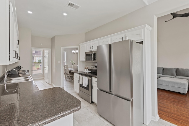 9071 E Tefall Cv, Cordova, TN 38016 - kitchen with appliances with stainless steel finishes, a sink, dark countertops, white cabinetry, and recessed lighting