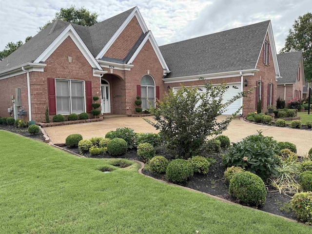 929 N Warwick Oaks Dr N, Collierville, TN 38017 - traditional-style house with brick siding, roof with shingles, concrete driveway, and a front yard