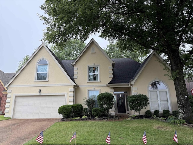 83 Mccall Dr, Collierville, TN 38017 - traditional-style house with stucco siding, concrete driveway, a garage, and a front lawn