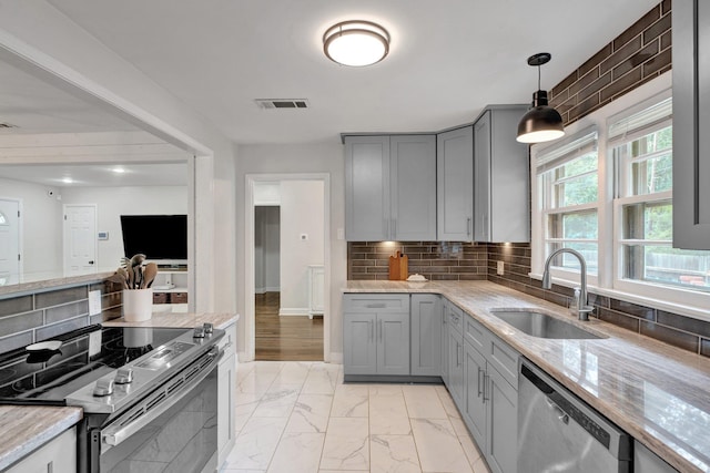 624 N Oak Grove Rd N, Memphis, TN 38120 - kitchen with appliances with stainless steel finishes, a sink, gray cabinets, light marble finish flooring, and light stone counters