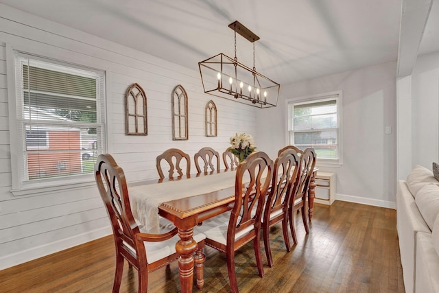 624 N Oak Grove Rd N, Memphis, TN 38120 - dining room featuring dark wood-style flooring, baseboards, a chandelier, and wooden walls