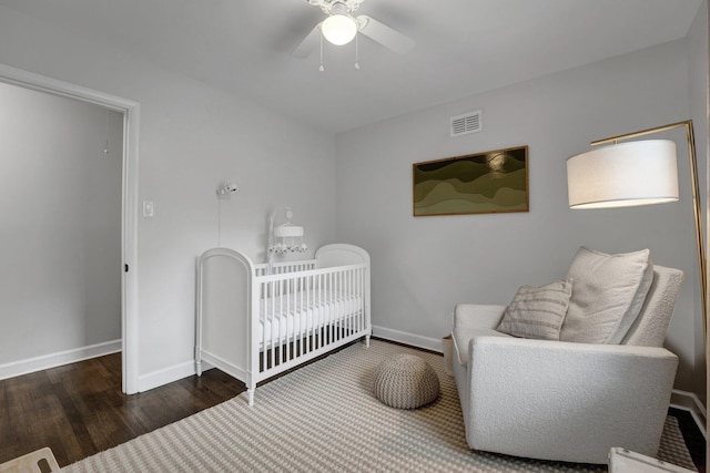 624 N Oak Grove Rd N, Memphis, TN 38120 - bedroom featuring wood finished floors, baseboards, ceiling fan, and a nursery area