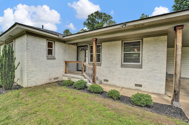 624 N Oak Grove Rd N, Memphis, TN 38120 - doorway to property featuring crawl space, brick siding, and a yard