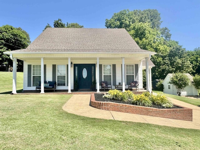 150 Westwood Cir, Ripley, TN 38063 - view of front of property with covered porch, a front yard, and roof with shingles