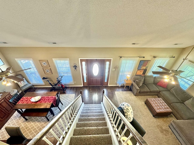 150 Westwood Cir, Ripley, TN 38063 - living room featuring ceiling fan, wood finished floors, a textured ceiling, plenty of natural light, and baseboards
