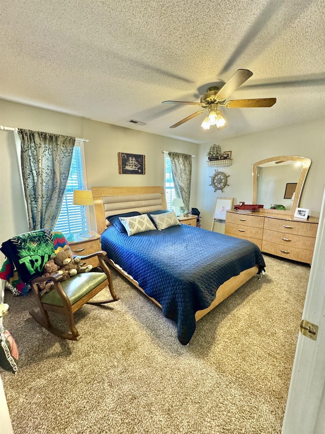 150 Westwood Cir, Ripley, TN 38063 - carpeted bedroom featuring multiple windows, a textured ceiling, and ceiling fan