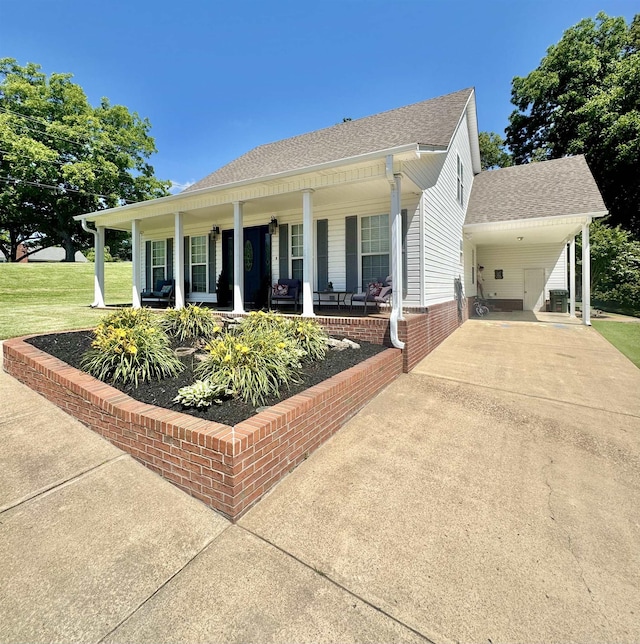 150 Westwood Cir, Ripley, TN 38063 - single story home featuring a porch, driveway, a shingled roof, a carport, and a front lawn