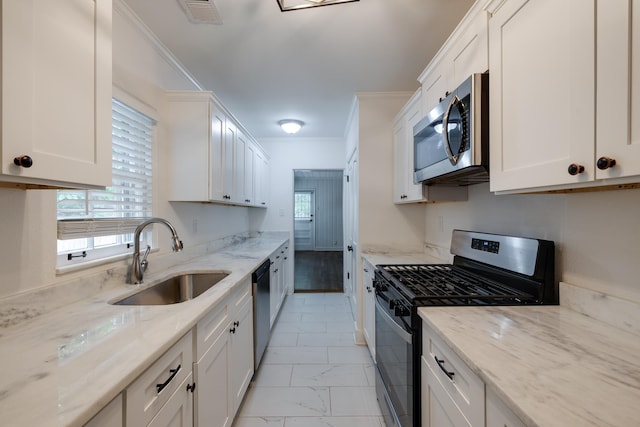 228 Palisade St, Memphis, TN 38111 - kitchen featuring stainless steel appliances, a sink, ornamental molding, plenty of natural light, and white cabinets