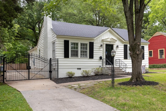 228 Palisade St, Memphis, TN 38111 - view of front facade with a gate, crawl space, a shingled roof, a chimney, and board and batten siding