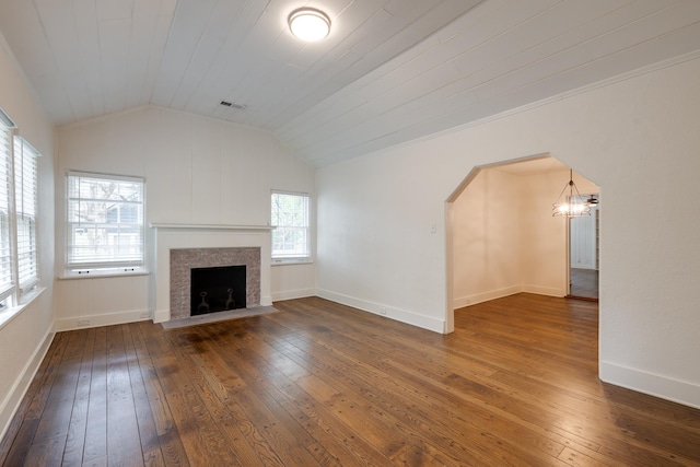 228 Palisade St, Memphis, TN 38111 - unfurnished living room featuring hardwood / wood-style flooring, a chandelier, a fireplace with flush hearth, lofted ceiling, and arched walkways