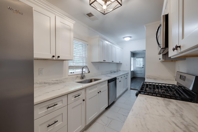 228 Palisade St, Memphis, TN 38111 - kitchen featuring stainless steel appliances, a sink, light marble finish floors, crown molding, and plenty of natural light