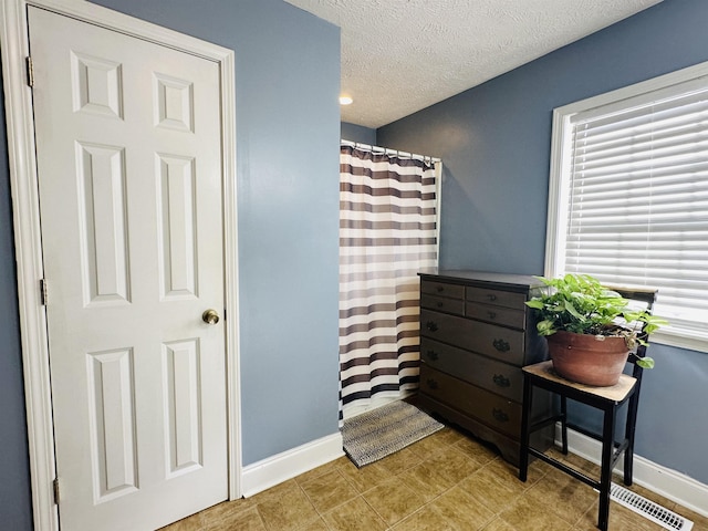1145 Cypress Tank Rd, Pocahontas, TN 38061 - full bathroom with baseboards, a textured ceiling, and a shower with shower curtain