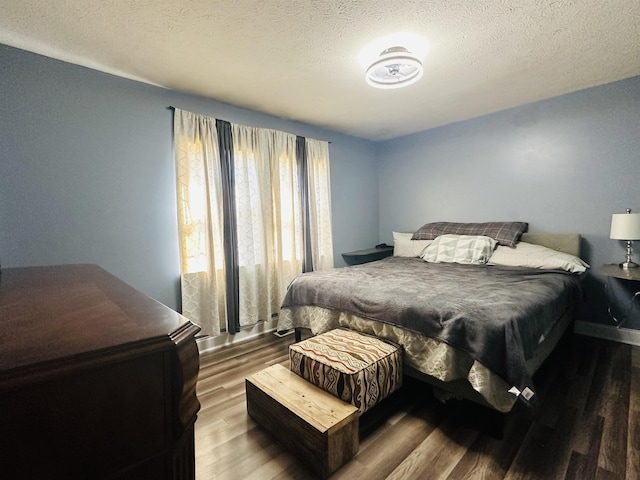 1145 Cypress Tank Rd, Pocahontas, TN 38061 - bedroom featuring wood finished floors, a textured ceiling, and baseboards