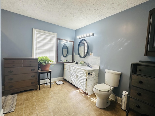 1145 Cypress Tank Rd, Pocahontas, TN 38061 - full bath with double vanity, toilet, a textured ceiling, and baseboards