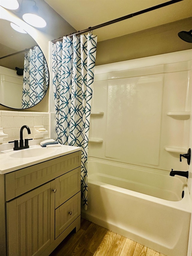 159 Hillhurst Dr, Selmer, TN 38375 - full bathroom featuring wood finished floors, shower / bath combo, vanity, and backsplash