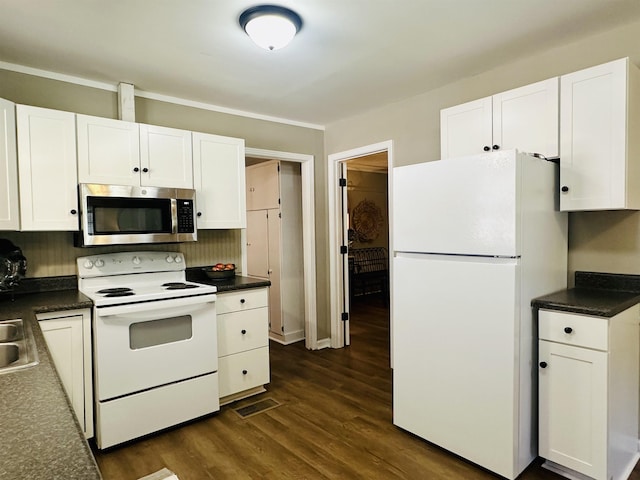 159 Hillhurst Dr, Selmer, TN 38375 - kitchen featuring white appliances, dark countertops, white cabinetry, and decorative backsplash