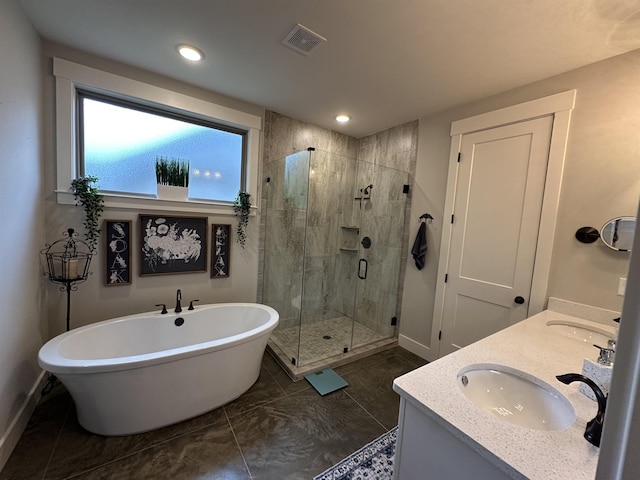 6104 Scottscraig Cv, Bartlett, TN 38135 - bathroom featuring baseboards, a freestanding bath, a shower stall, double vanity, and recessed lighting