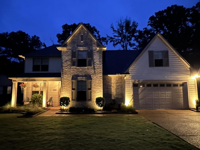 6104 Scottscraig Cv, Bartlett, TN 38135 - traditional home with a garage, concrete driveway, a yard, and stone siding