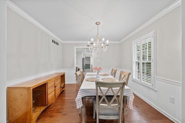 1772 Old Mill Rd, Germantown, TN 38138 - dining space featuring a chandelier, a wainscoted wall, dark wood-type flooring, and crown molding
