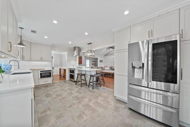1772 Old Mill Rd, Germantown, TN 38138 - kitchen featuring appliances with stainless steel finishes, tasteful backsplash, wall chimney range hood, ornamental molding, and a sink