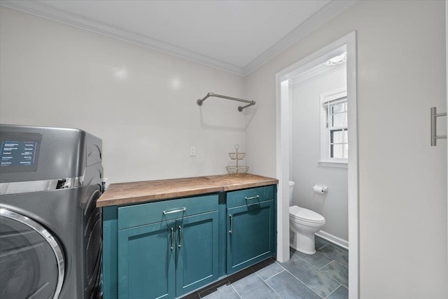 1772 Old Mill Rd, Germantown, TN 38138 - washroom with washer / clothes dryer, crown molding, and cabinet space