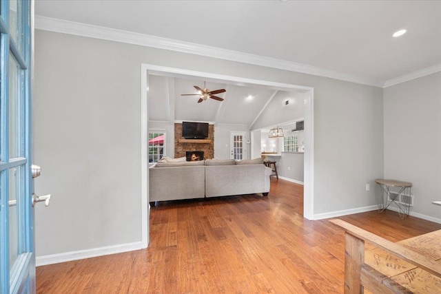 1772 Old Mill Rd, Germantown, TN 38138 - living room featuring wood finished floors, a stone fireplace, ceiling fan, baseboards, and vaulted ceiling
