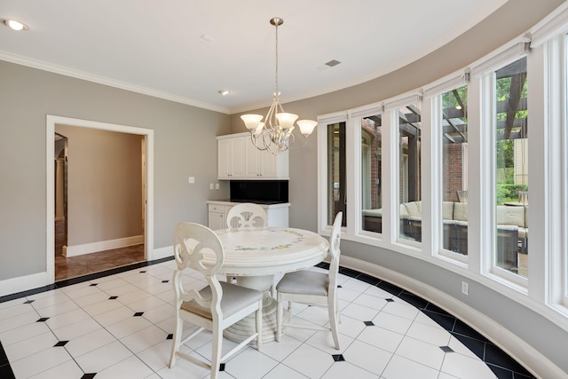 415 S Yates Cv, Memphis, TN 38120 - dining area with light tile patterned floors, a chandelier, ornamental molding, baseboards, and inlaid floor details