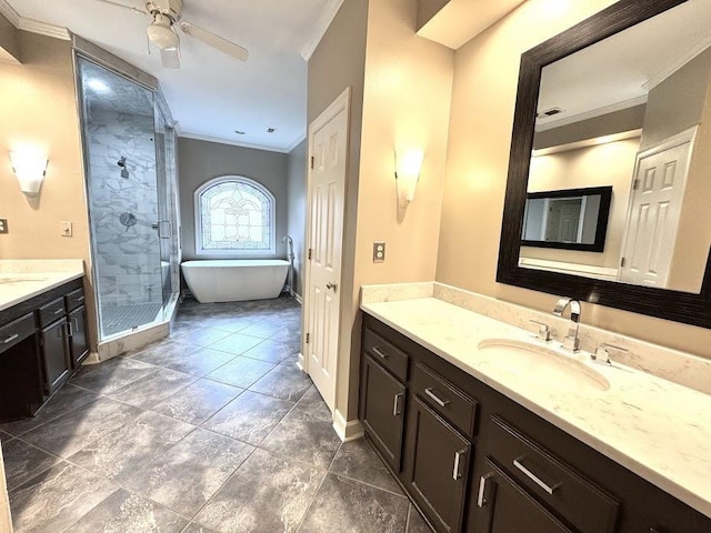 415 S Yates Cv, Memphis, TN 38120 - full bath with crown molding, vanity, a stall shower, a freestanding bath, and baseboards