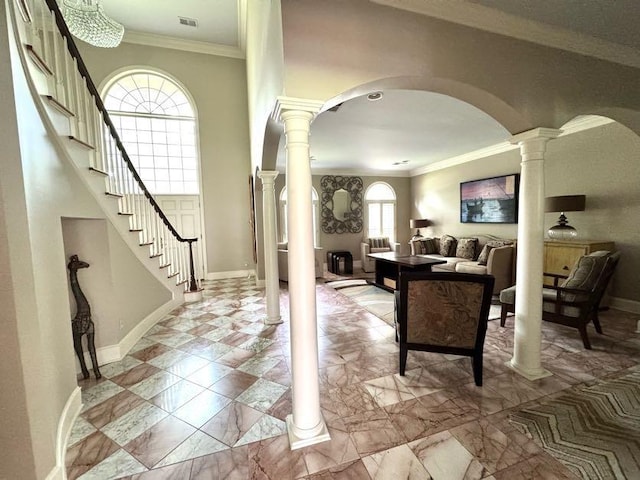 415 S Yates Cv, Memphis, TN 38120 - entryway with arched walkways, ornate columns, stairway, crown molding, and baseboards