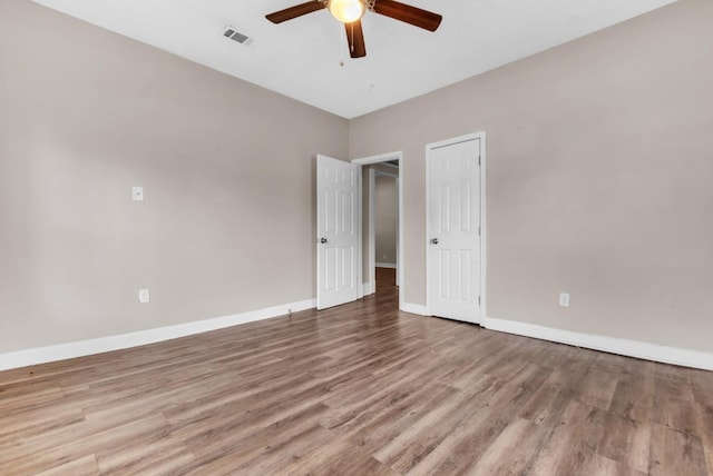 1148 Rozelle St, Memphis, TN 38106 - spare room featuring wood finished floors, a ceiling fan, and baseboards