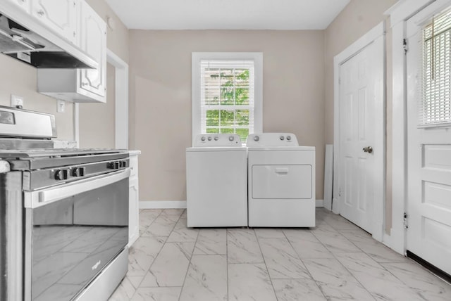 1148 Rozelle St, Memphis, TN 38106 - laundry area with light marble finish floors, washing machine and dryer, and baseboards