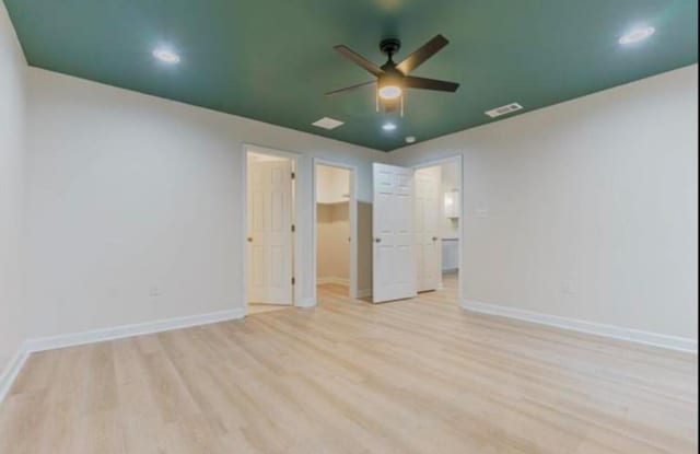 4100 New Willow Rd, Memphis, TN 38111 - unfurnished bedroom with light wood-type flooring, a walk in closet, baseboards, recessed lighting, and a ceiling fan