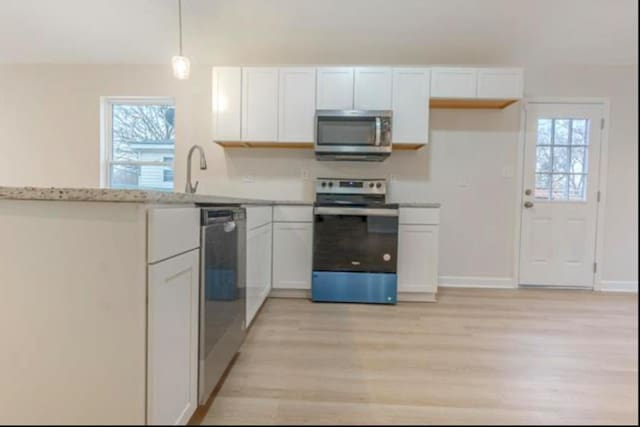 4100 New Willow Rd, Memphis, TN 38111 - kitchen with stainless steel appliances, light wood-type flooring, plenty of natural light, and white cabinets
