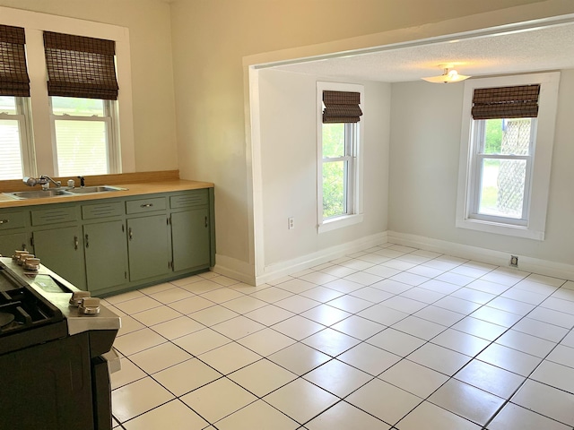 119 Red Bird Rd, Middleton, TN 38052 - kitchen featuring a sink, green cabinetry, healthy amount of natural light, and light tile patterned floors