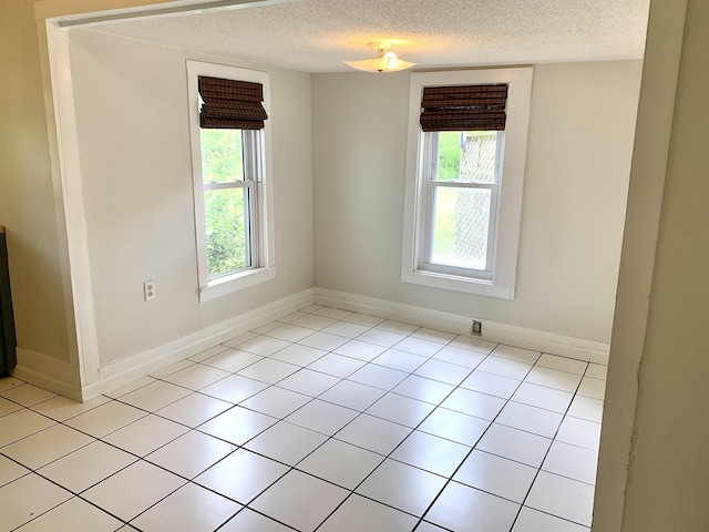 119 Red Bird Rd, Middleton, TN 38052 - spare room featuring healthy amount of natural light, a textured ceiling, baseboards, and light tile patterned floors