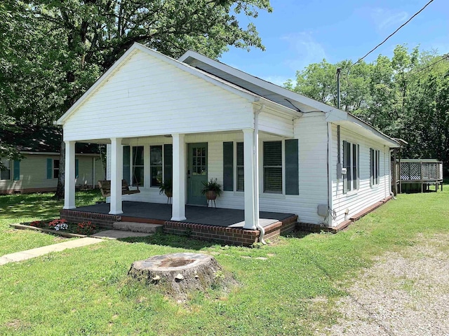 119 Red Bird Rd, Middleton, TN 38052 - view of front facade featuring a porch, a front lawn, and an outdoor fire pit