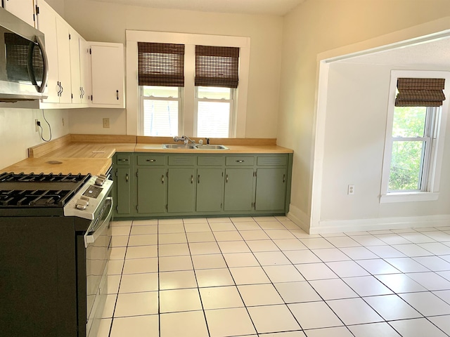 119 Red Bird Rd, Middleton, TN 38052 - kitchen featuring appliances with stainless steel finishes, green cabinets, a sink, light countertops, and light tile patterned floors