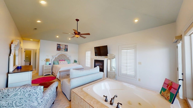 410 Shipwatch Pt, Savannah, TN 38372 - bedroom with recessed lighting, lofted ceiling, a glass covered fireplace, and a ceiling fan