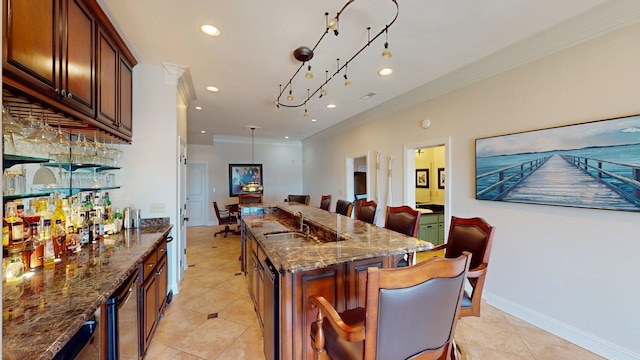 410 Shipwatch Pt, Savannah, TN 38372 - kitchen featuring a kitchen breakfast bar, a sink, crown molding, dark stone countertops, and light tile patterned floors