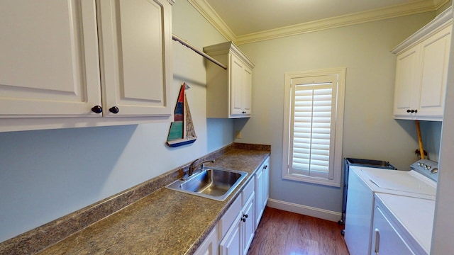 410 Shipwatch Pt, Savannah, TN 38372 - laundry area featuring separate washer and dryer, cabinet space, dark wood-style flooring, ornamental molding, and baseboards