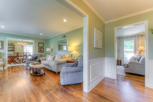 4834 Welchshire Ave, Memphis, TN 38117 - living room featuring a chandelier, wood finished floors, wainscoting, ornamental molding, and recessed lighting